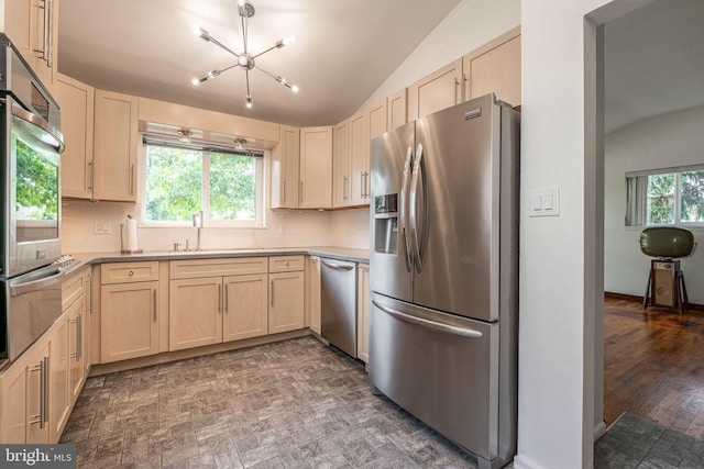 7129 Chandler Ave, Pennsauken, NJ 08110 - kitchen featuring stainless steel appliances, lofted ceiling, light brown cabinetry, a sink, and backsplash