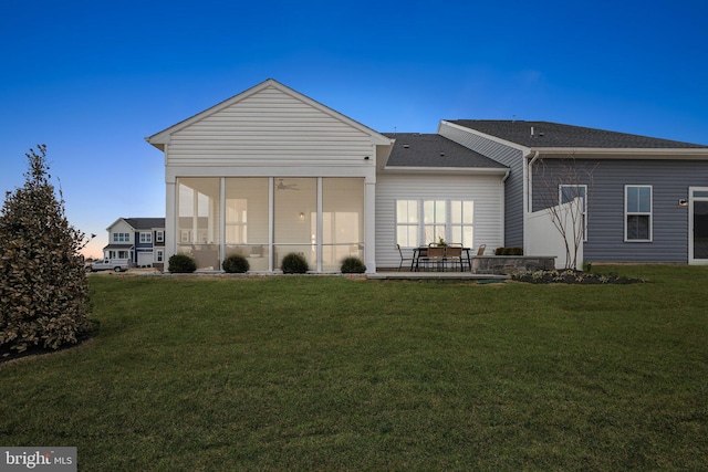 1052 Webster Ct, Winchester, VA 22603 - back of property featuring a yard, a patio area, a shingled roof, and a sunroom