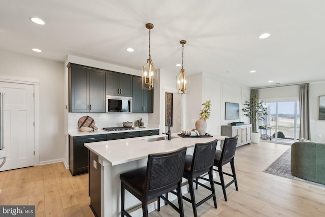 1052 Webster Ct, Winchester, VA 22603 - kitchen featuring a sink, light wood-style floors, light countertops, decorative backsplash, and recessed lighting