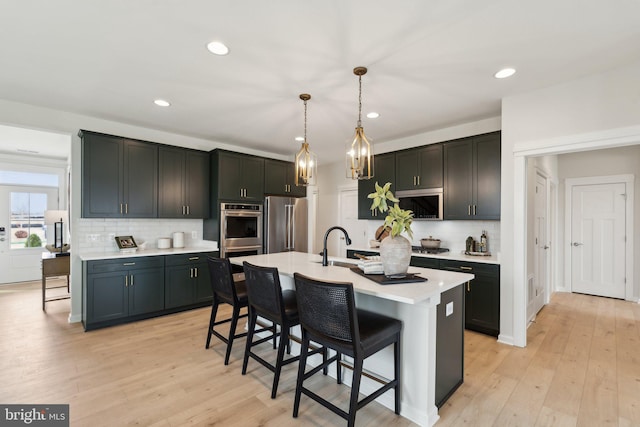 1052 Webster Ct, Winchester, VA 22603 - kitchen with a breakfast bar, stainless steel appliances, light countertops, backsplash, and recessed lighting