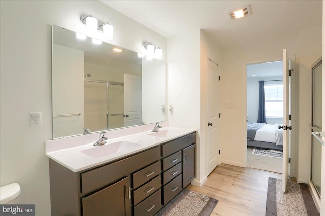 6300 Neha Dr Unit 32, Mechanicsburg, PA 17050 - bathroom with wood finished floors, double vanity, a shower stall, ensuite bath, and toilet