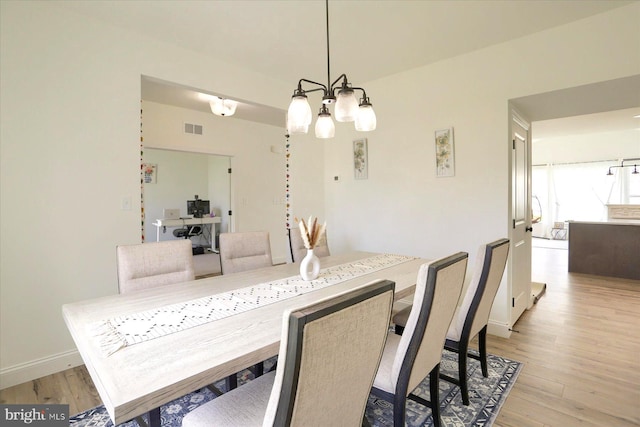 6300 Neha Dr Unit 32, Mechanicsburg, PA 17050 - dining space with light wood-style flooring, a chandelier, a desk, and baseboards