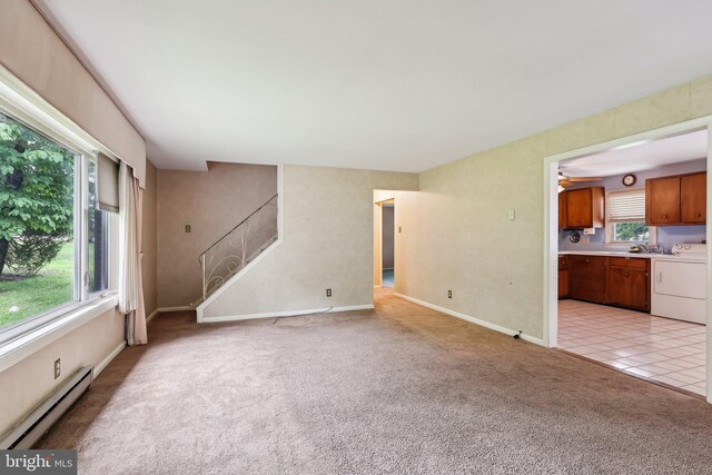 1927 Chapel Ave W, Cherry Hill, NJ 08002 - unfurnished living room featuring a baseboard radiator, light carpet, baseboards, separate washer and dryer, and light tile patterned floors