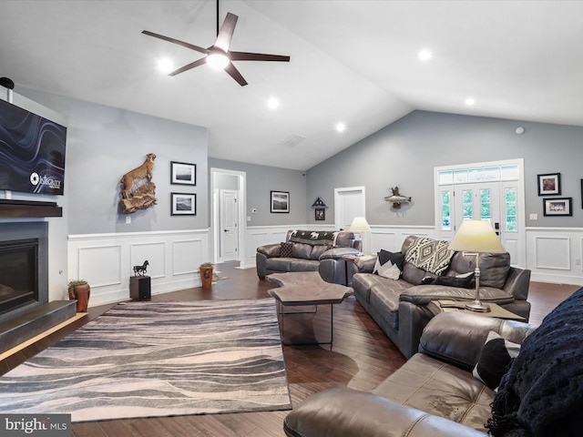 3447 Old Leetown Pike, Ranson, WV 25438 - living area featuring ceiling fan, wood finished floors, a glass covered fireplace, wainscoting, and vaulted ceiling
