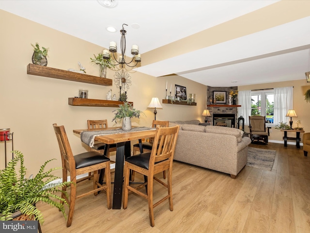 41 E Frederick St, Williamsport, MD 21795 - dining area with light wood finished floors, a large fireplace, a chandelier, and baseboards