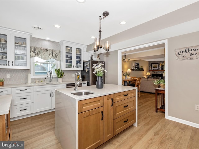 41 E Frederick St, Williamsport, MD 21795 - kitchen featuring a sink, a chandelier, a center island with sink, freestanding refrigerator, and decorative backsplash