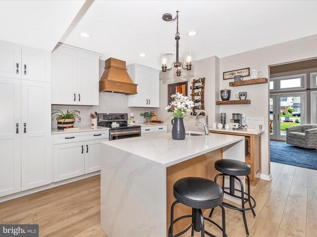 41 E Frederick St, Williamsport, MD 21795 - kitchen featuring stainless steel range with electric cooktop, custom range hood, open shelves, a sink, and light wood-type flooring