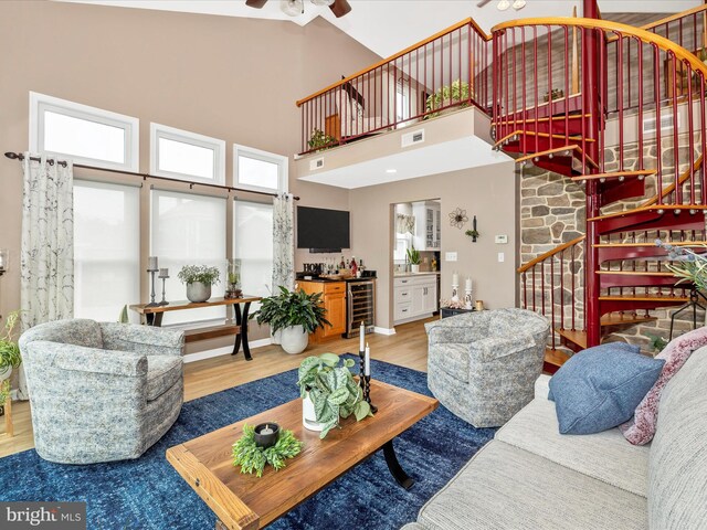 41 E Frederick St, Williamsport, MD 21795 - living room with stairway, wood finished floors, a towering ceiling, a ceiling fan, and beverage cooler