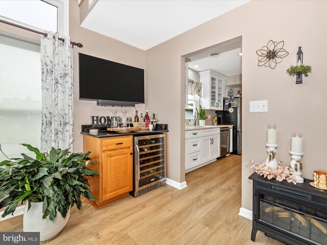 41 E Frederick St, Williamsport, MD 21795 - indoor bar featuring beverage cooler, light wood finished floors, stainless steel dishwasher, and baseboards
