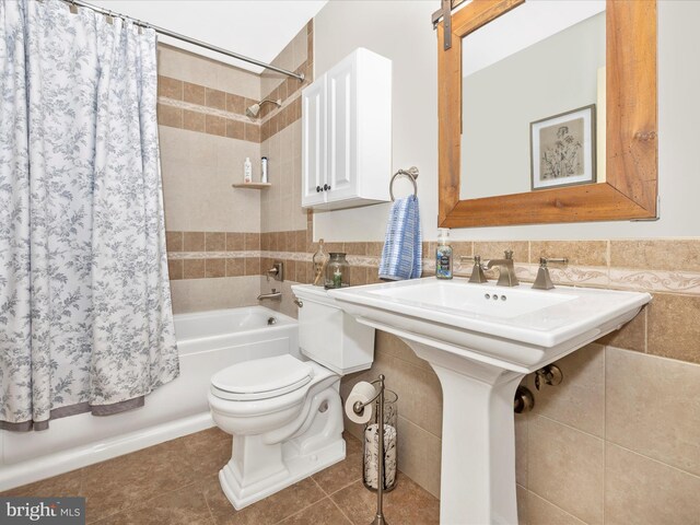 41 E Frederick St, Williamsport, MD 21795 - full bathroom featuring shower / bath combo, toilet, tile walls, tile patterned floors, and a sink