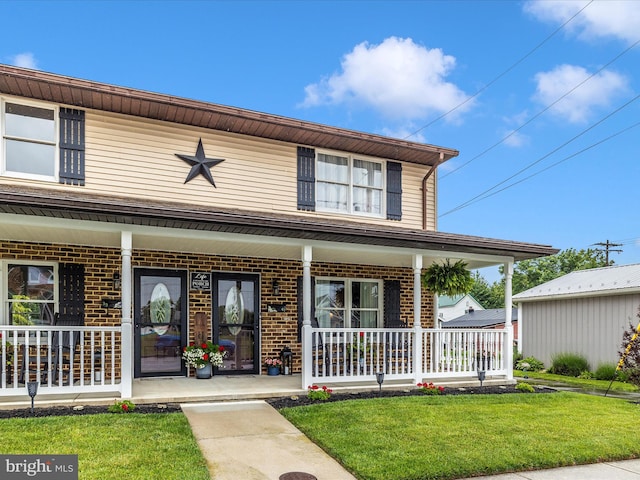 41 E Frederick St, Williamsport, MD 21795 - view of front of home with a porch, brick siding, and a front yard