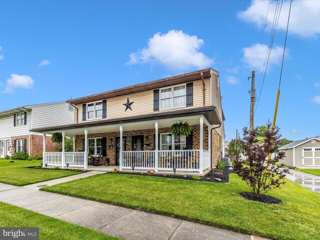41 E Frederick St, Williamsport, MD 21795 - view of front of home with brick siding, a porch, and a front lawn