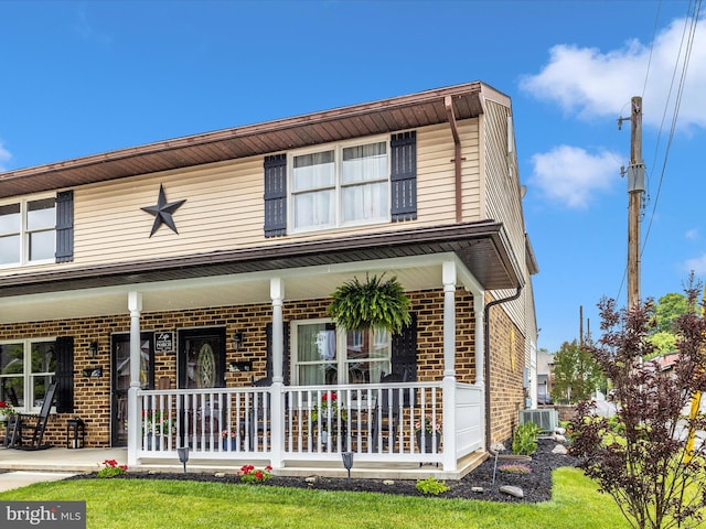41 E Frederick St, Williamsport, MD 21795 - traditional home featuring brick siding, covered porch, and central AC unit