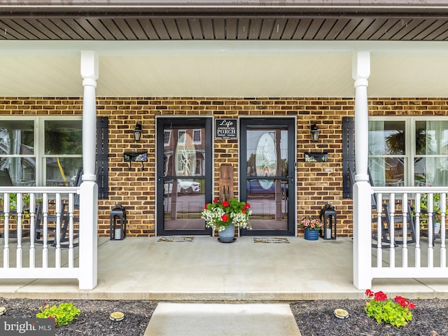 41 E Frederick St, Williamsport, MD 21795 - doorway to property featuring brick siding and a porch