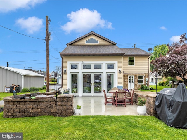 41 E Frederick St, Williamsport, MD 21795 - back of house with french doors, a lawn, a patio area, and a shingled roof