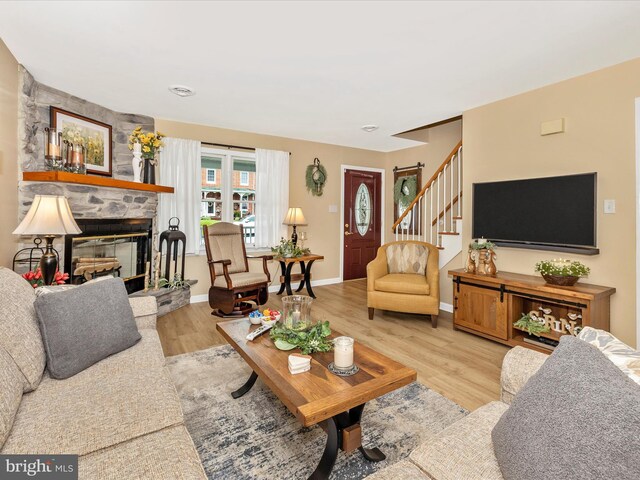 41 E Frederick St, Williamsport, MD 21795 - living room featuring stairway, light wood-style floors, a fireplace, and baseboards