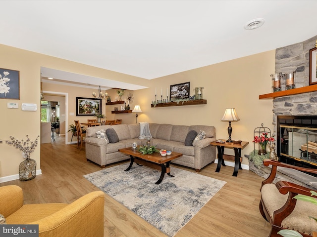 41 E Frederick St, Williamsport, MD 21795 - living room with light wood-type flooring, baseboards, and a stone fireplace