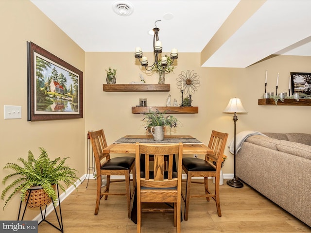41 E Frederick St, Williamsport, MD 21795 - dining room featuring light wood-style floors, a chandelier, and baseboards