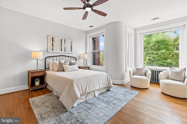 121 V St NW, Washington, DC 20001 - bedroom with wood-type flooring, baseboards, ceiling fan, and radiator heating unit