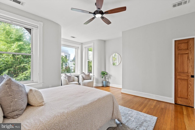 121 V St NW, Washington, DC 20001 - bedroom featuring baseboards, multiple windows, and light wood-type flooring