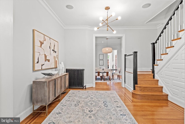 121 V St NW, Washington, DC 20001 - entrance foyer with radiator heating unit, a chandelier, stairway, crown molding, and light wood-style floors