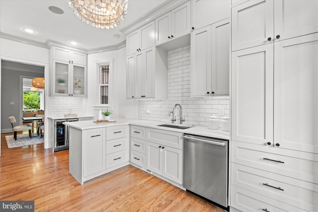 121 V St NW, Washington, DC 20001 - kitchen with stainless steel dishwasher, a sink, beverage cooler, light countertops, and backsplash
