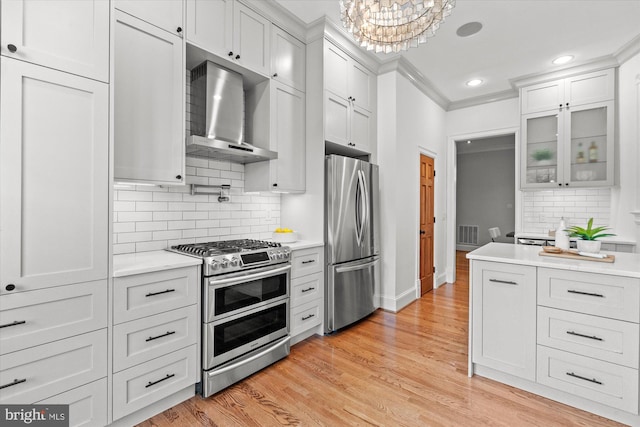 121 V St NW, Washington, DC 20001 - kitchen featuring stainless steel appliances, wall chimney range hood, light countertops, glass insert cabinets, and crown molding