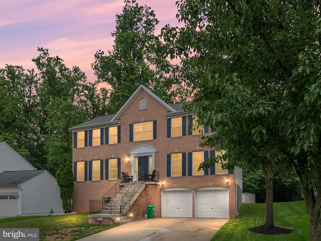 3716 Hill Park Dr, Temple Hills, MD 20748 - colonial inspired home featuring brick siding, driveway, an attached garage, and a front lawn
