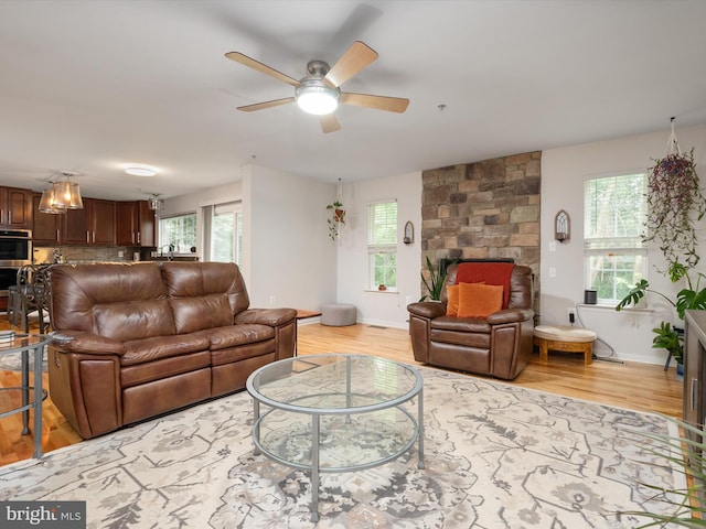 3716 Hill Park Dr, Temple Hills, MD 20748 - living area featuring light wood-style floors, ceiling fan, and a fireplace