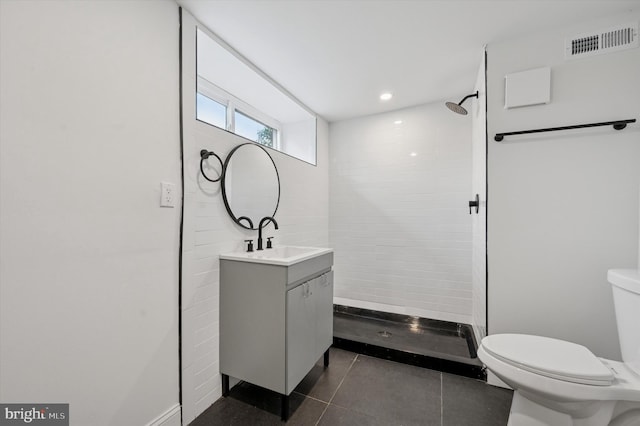 1740 N 61st St, Philadelphia, PA 19151 - full bathroom featuring vanity, toilet, a tile shower, tile patterned floors, and baseboards