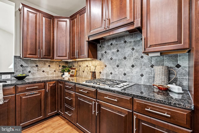 4403 Cedar Reach Ln, Bowie, MD 20720 - kitchen with stainless steel gas stovetop, dark stone countertops, light wood-style flooring, and backsplash