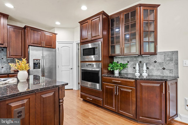 4403 Cedar Reach Ln, Bowie, MD 20720 - kitchen with appliances with stainless steel finishes, light wood-type flooring, glass insert cabinets, decorative backsplash, and recessed lighting