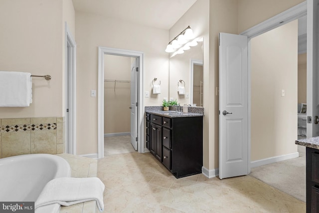 4403 Cedar Reach Ln, Bowie, MD 20720 - full bathroom featuring vanity, a spacious closet, and a tub to relax in