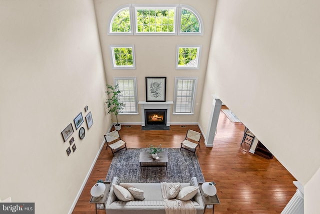 4403 Cedar Reach Ln, Bowie, MD 20720 - living room with a fireplace with flush hearth, wood finished floors, and a high ceiling