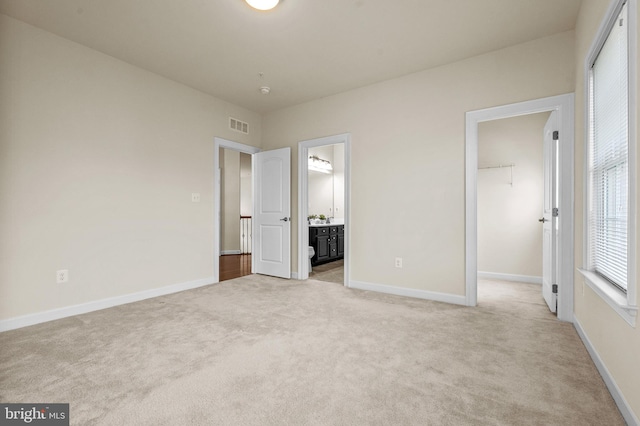 4403 Cedar Reach Ln, Bowie, MD 20720 - unfurnished bedroom featuring light carpet, a walk in closet, ensuite bathroom, and a closet