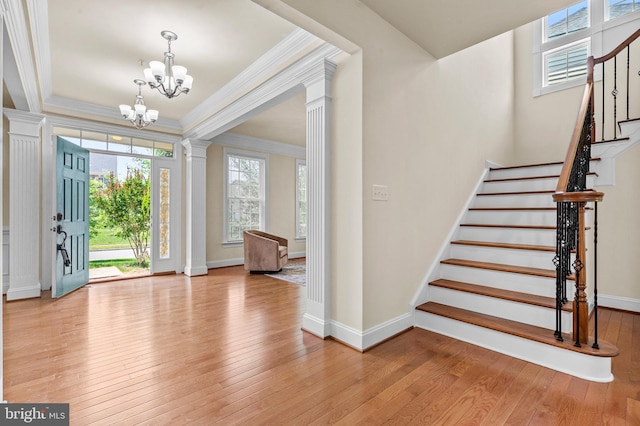4403 Cedar Reach Ln, Bowie, MD 20720 - entryway with crown molding, a chandelier, ornate columns, stairs, and light wood finished floors