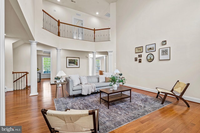 4403 Cedar Reach Ln, Bowie, MD 20720 - living area featuring decorative columns, wood finished floors, a towering ceiling, and recessed lighting