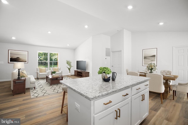 LOT2 Indiantown Rd, King George, VA 22485 - kitchen with lofted ceiling, wood finished floors, a center island, open floor plan, and white cabinetry