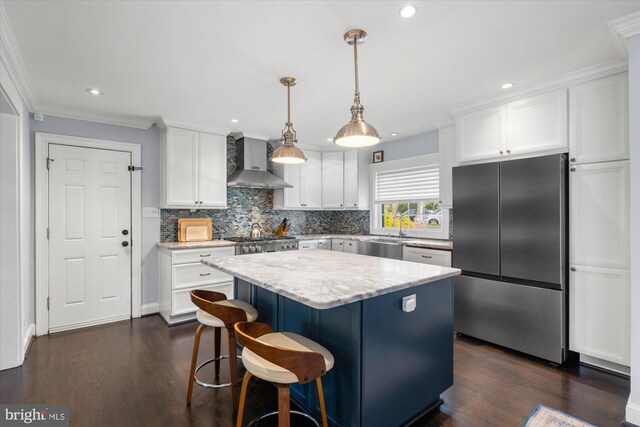 1426 Highwood Dr, Mclean, VA 22101 - kitchen with freestanding refrigerator, wall chimney exhaust hood, white cabinetry, a center island, and decorative backsplash