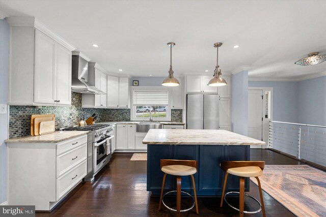 1426 Highwood Dr, Mclean, VA 22101 - kitchen featuring wall chimney exhaust hood, stainless steel appliances, a kitchen island, white cabinets, and a sink