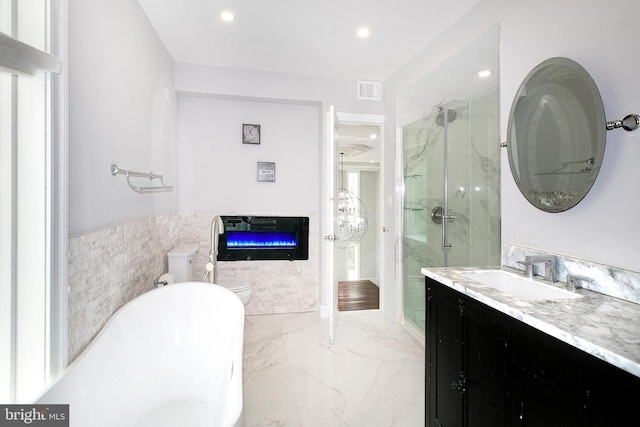 2001 Army Navy Dr, Arlington, VA 22202 - bathroom with a marble finish shower, a soaking tub, vanity, a glass covered fireplace, and marble tiled floors