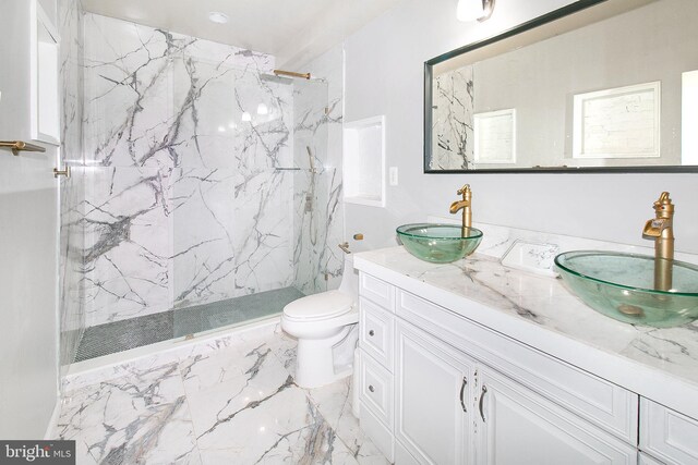 2001 Army Navy Dr, Arlington, VA 22202 - bathroom with double vanity, a marble finish shower, toilet, and marble finish flooring