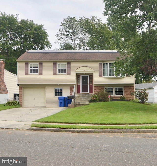 7 Caldwell Ave, Marlton, NJ 08053 - raised ranch featuring solar panels, an attached garage, driveway, a front yard, and entry steps