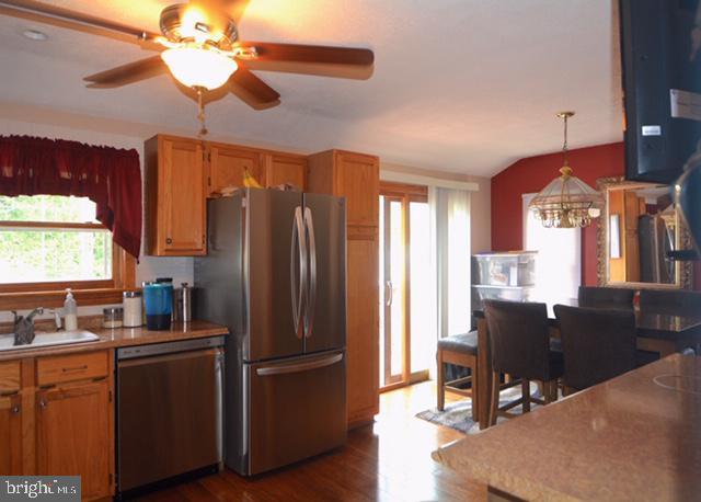 7 Caldwell Ave, Marlton, NJ 08053 - kitchen featuring appliances with stainless steel finishes, a sink, a chandelier, dark wood-style flooring, and a ceiling fan