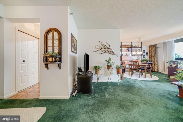 5501 Seminary Rd Unit 401S, Falls Church, VA 22041 - living area featuring carpet floors, a chandelier, a textured ceiling, and baseboards