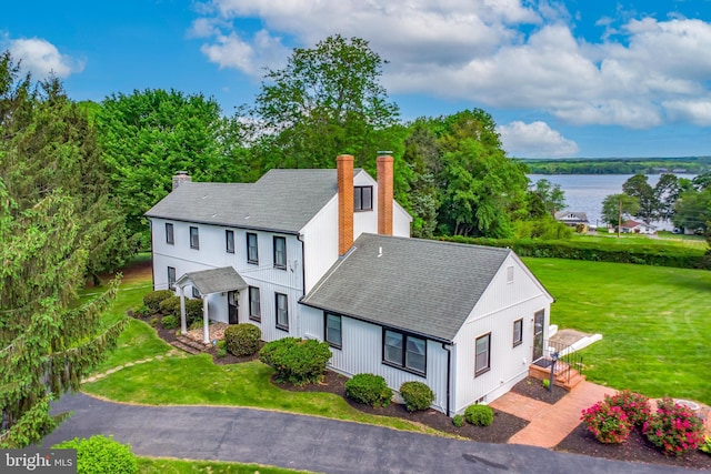 65 Hillcrest Ln, North East, MD 21901 - view of side of property featuring a chimney, a water view, roof with shingles, and a yard