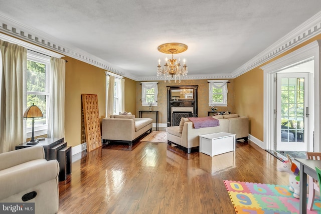 65 Hillcrest Ln, North East, MD 21901 - living room featuring a chandelier, wood finished floors, baseboards, and crown molding