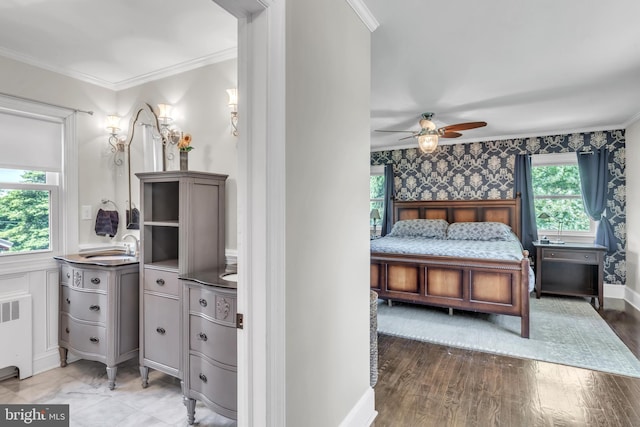 65 Hillcrest Ln, North East, MD 21901 - bedroom featuring radiator, ornamental molding, wood finished floors, wallpapered walls, and a wainscoted wall