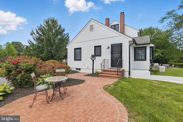 65 Hillcrest Ln, North East, MD 21901 - back of house featuring a lawn, a chimney, a patio, and roof with shingles