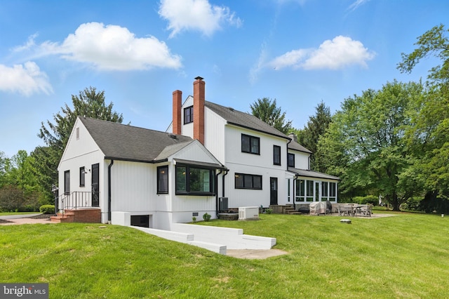 65 Hillcrest Ln, North East, MD 21901 - rear view of house featuring a lawn, a chimney, a patio area, and a shingled roof
